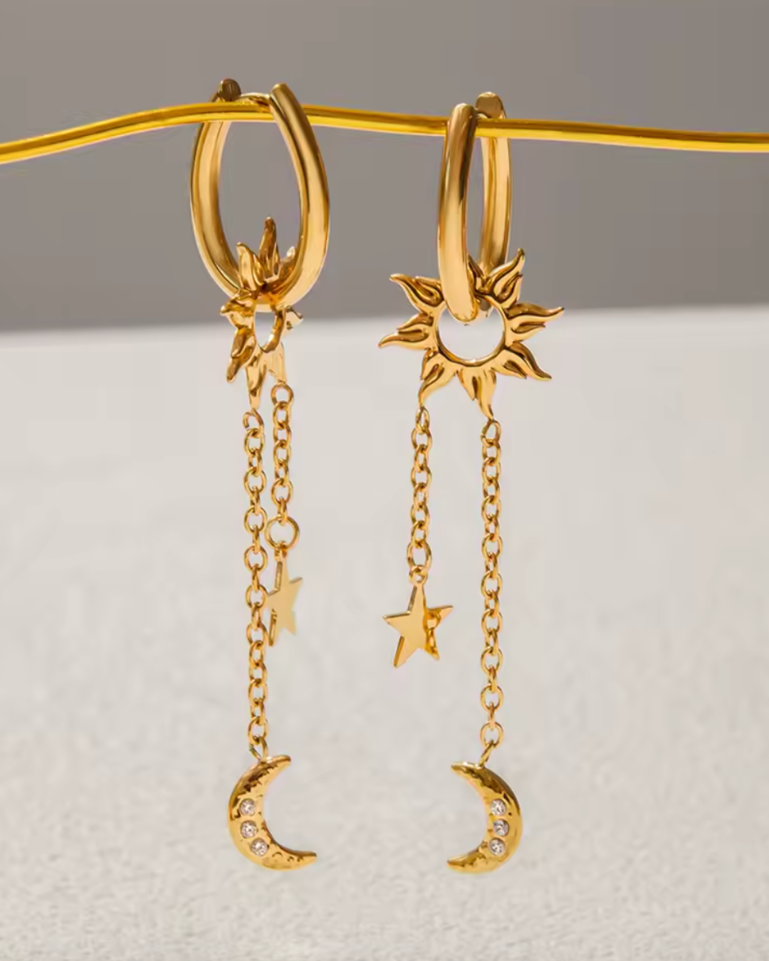 gold dangling star and moon hoops close-up – product detail